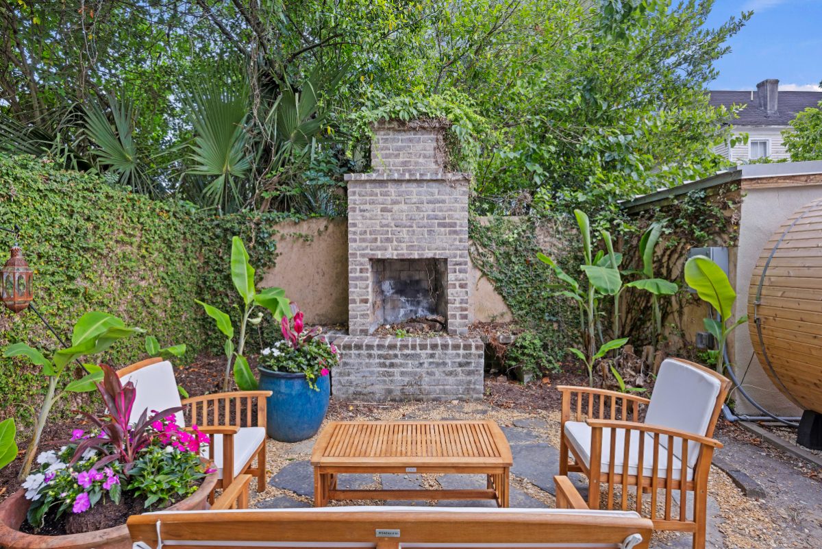 Breezy Palm, courtyard with brick outdoor fireplace